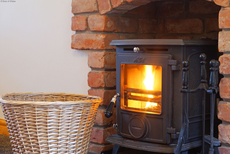 Large, warm and inviting lounge with comfortable seating & logburner