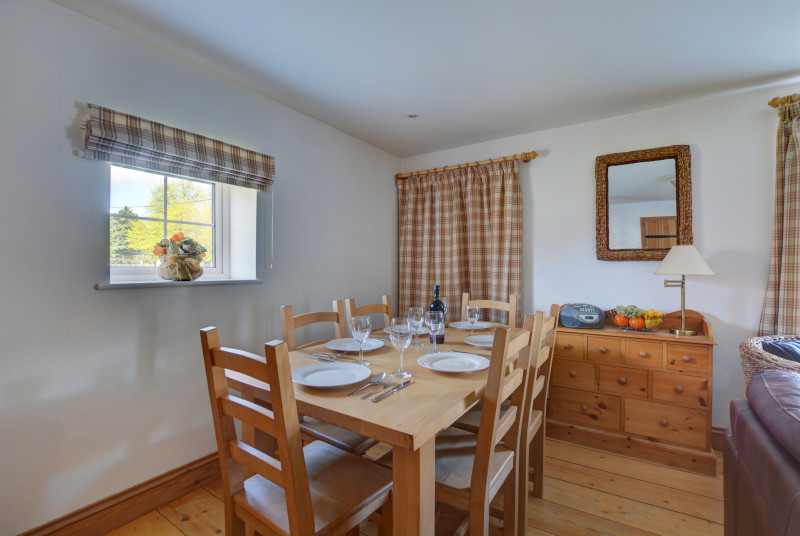Light and airy dining area with table and chairs, perfect for family meals