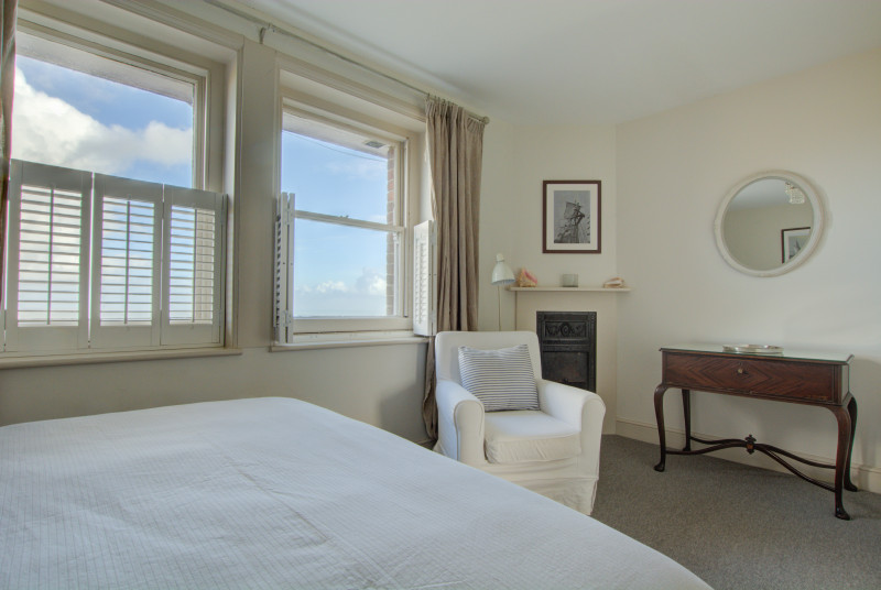 View showing dressing table area with original fireplace