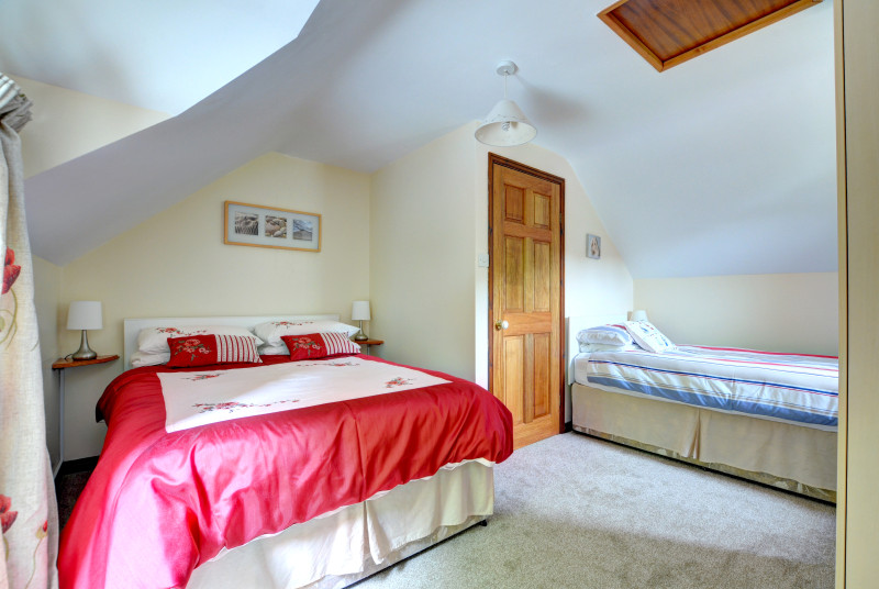 Family bedroom, includes a double bed and single bed, wardrobes and chest of drawers
