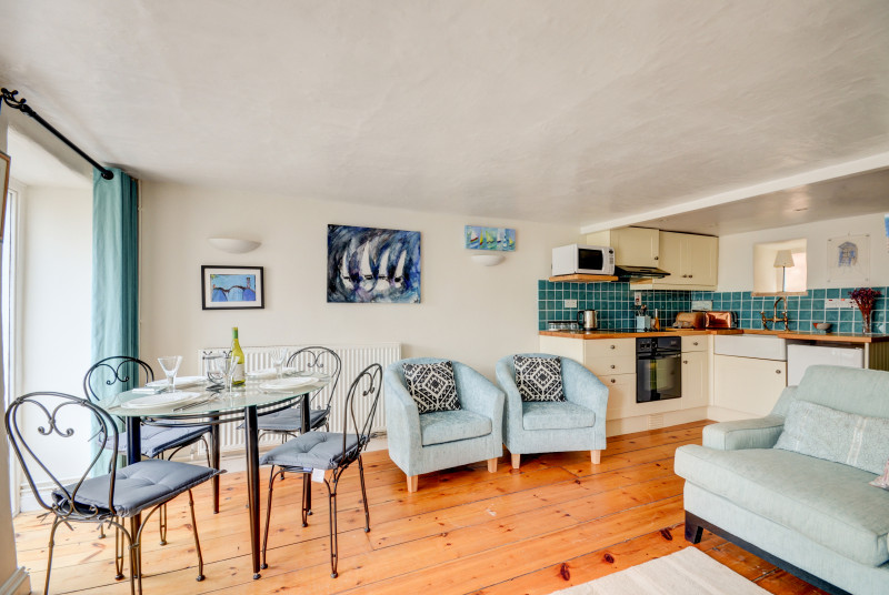 Living area with comfortable seating, and dining table and chairs