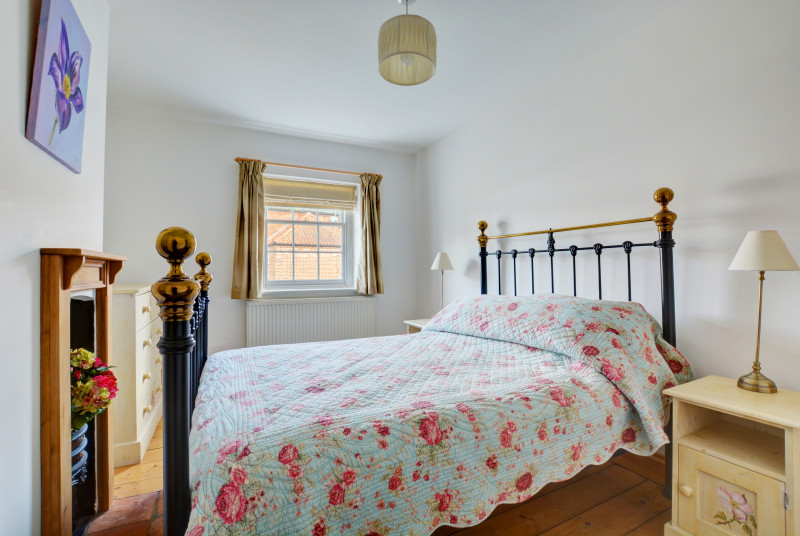 Double bedroom, tastefully furnished with a wrought iron bedstead