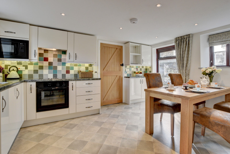 The well equipped kitchen with an attractive dining area overlooks the courtyard
