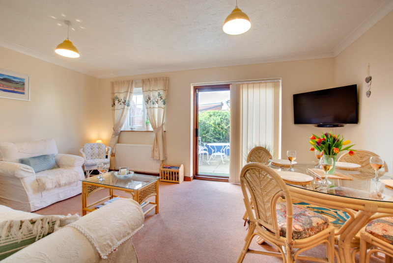 Bright sitting room with dining area which leads out to the courtyard