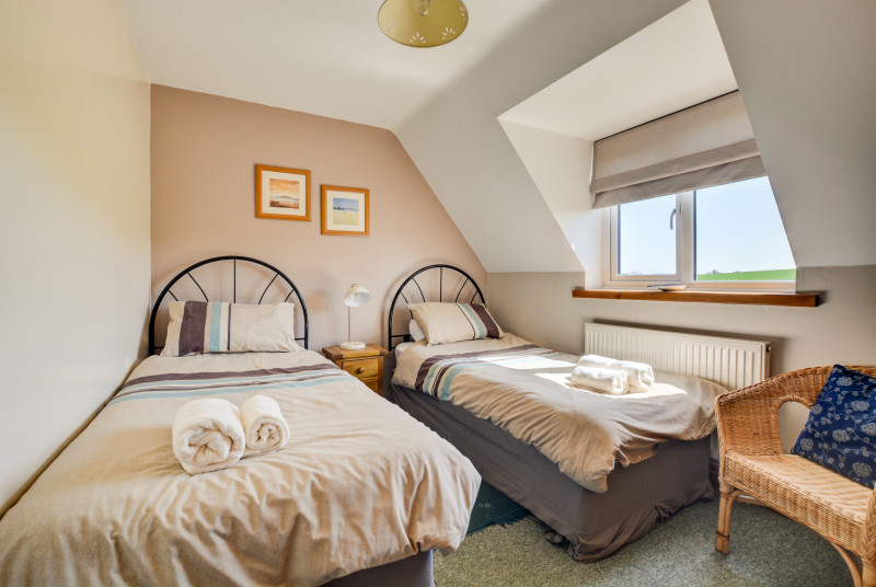 Cosy but light twin bedded room with seating