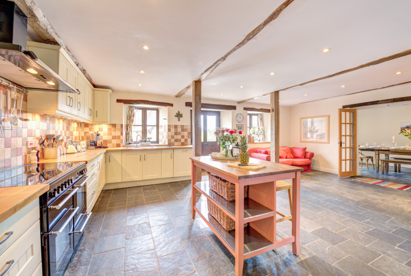 The well-equipped kitchen has a large range oven and American fridge/freezer