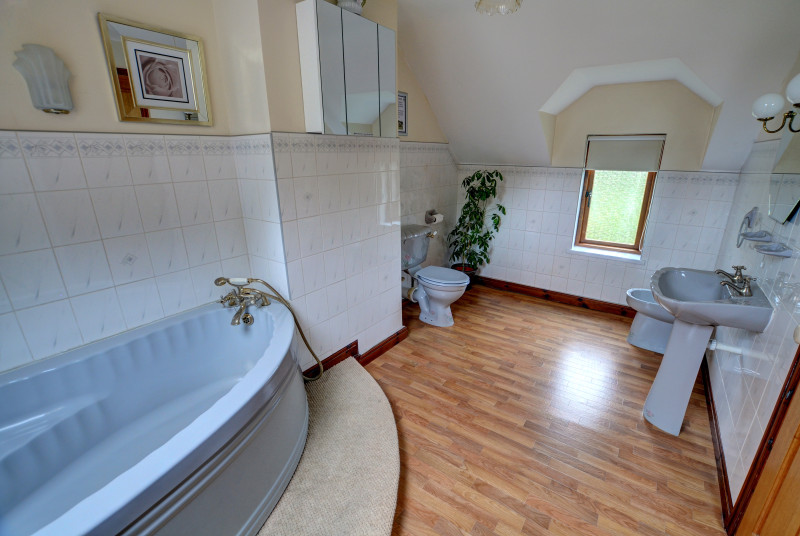 Large family bathroom on the first floor, has a corner bath, WC and bidet
