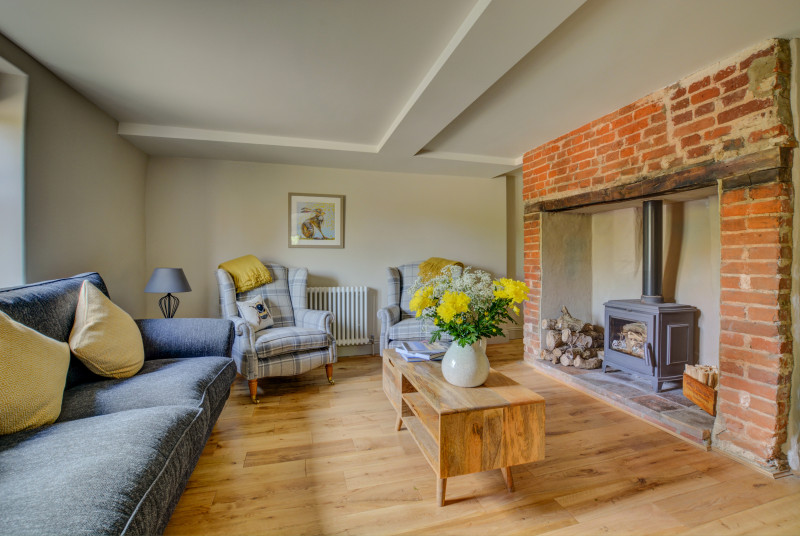 Sitting room showing wood burner and comfortable seating
