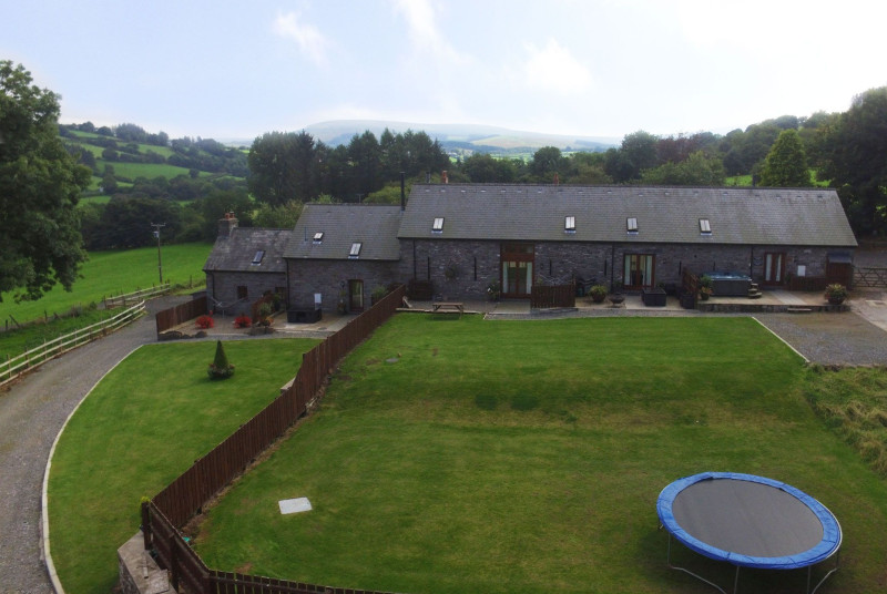 Large lawned area  with trampline