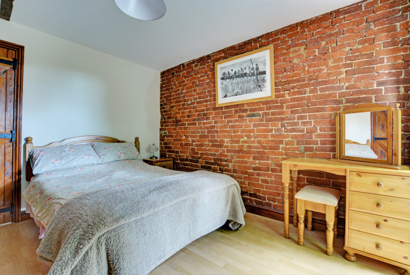 Characterful double bedroom with a double bed and exposed brickwork