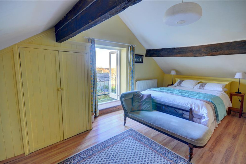 Bedroom with Juliet balcony overlooking the surrounding countryside.