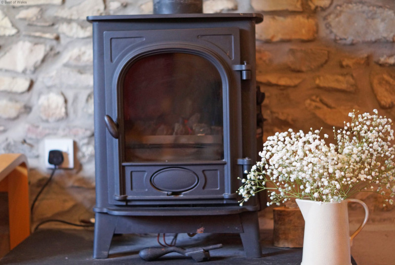 Lounge area features an oil-fired log burner to create a cosy and inviting atmosphere