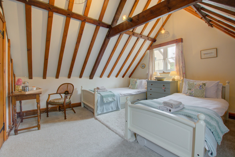 Bedroom two is another delightful room with rustic beams and has two single beds
