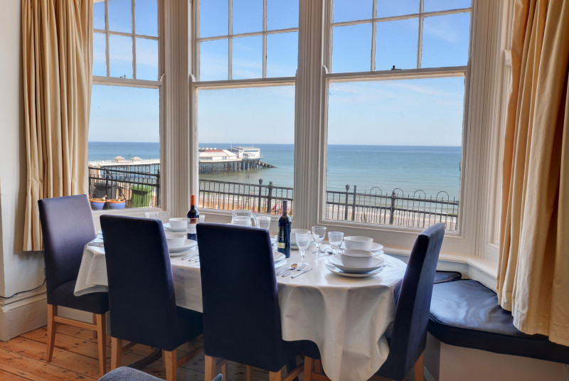 The dining area by the window has stunning views to the sea.