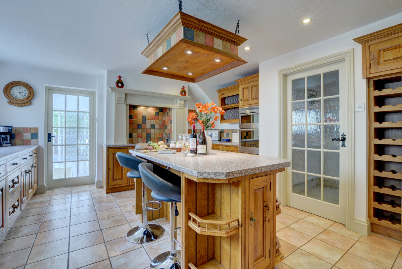 The kitchen has a useful island with bar stools