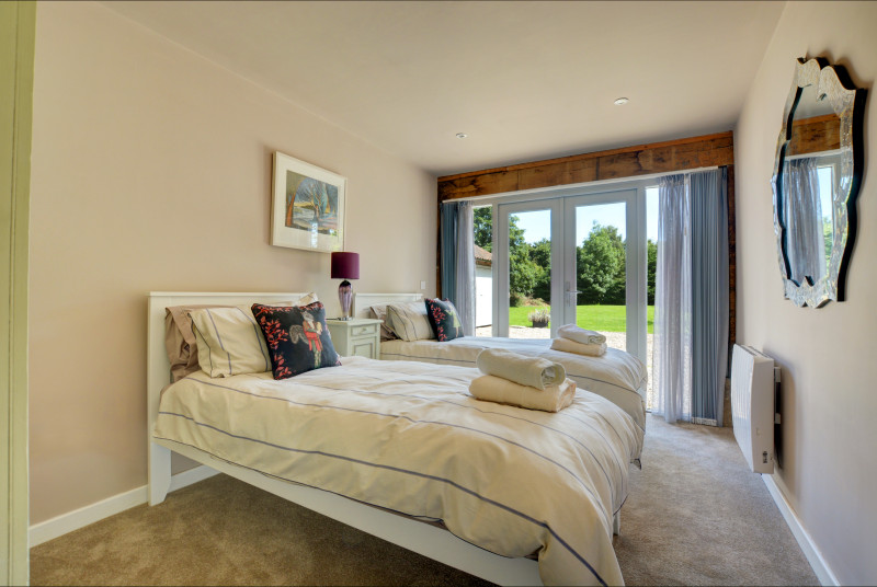 Bedroom 2 with twin beds and views of the garden
