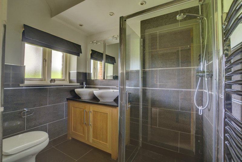 En-suite with twin washbasin, shower cubicle and wc