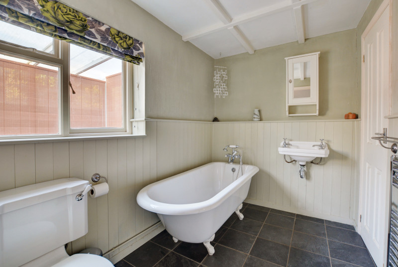 Bathroom with roll top bath, washbasin and wc