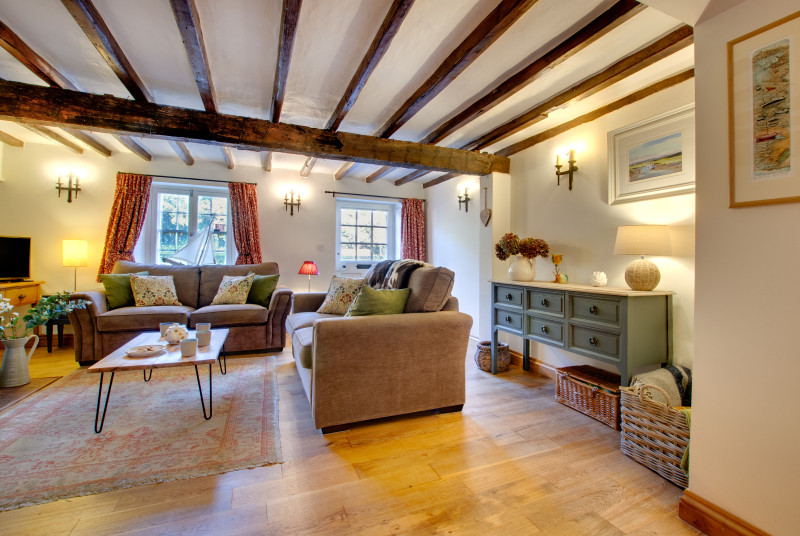 The thoughtfully decorated sitting room with traditional beams 