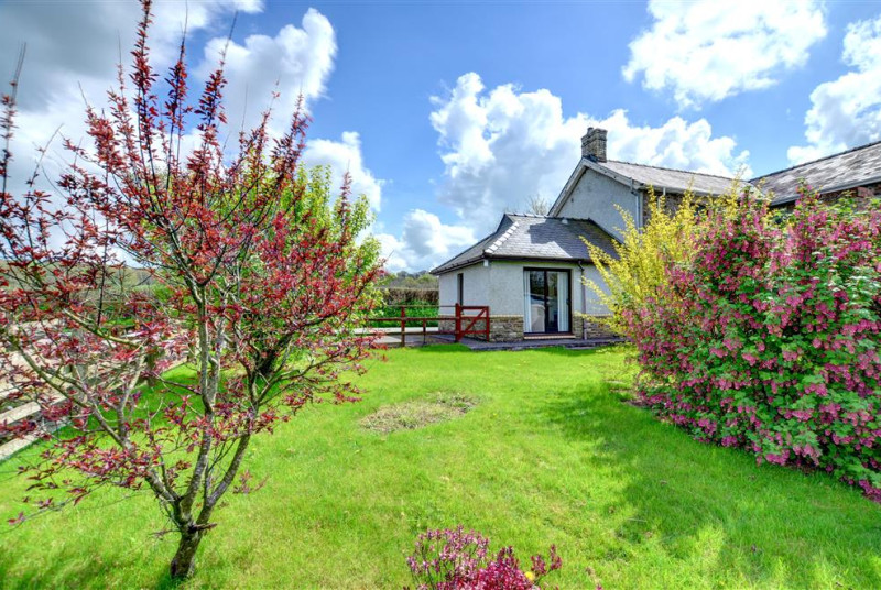 The cottage has pretty lawned gardens