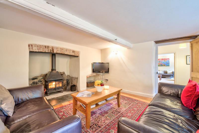 Cosy sitting room with log burner