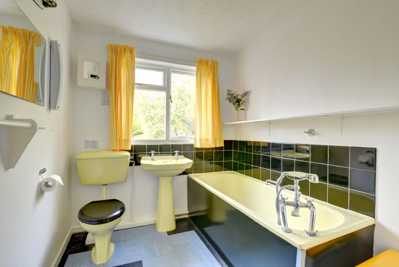 This property also has a bath, yellow and black themed furnishings