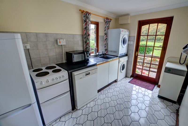 The separate utility room has an electric cooker, microwave, dishwasher, washing machine, tumble dryer, sink and a fridge/freezer