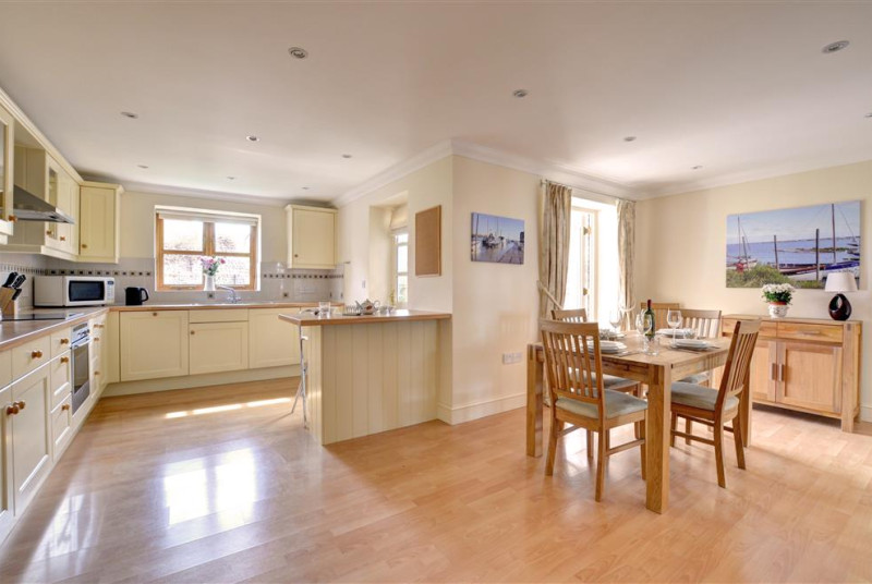 Kitchen and dining area with table set for four