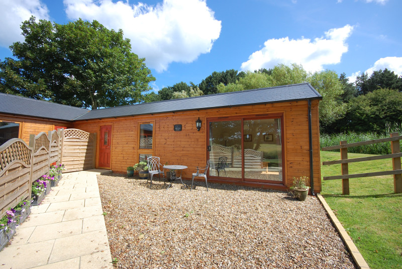 An attractive exterior view of the timber-clad single storey building.