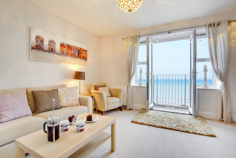 Sitting Room with comfortable seating, french doors with juliet balcony & sea views
