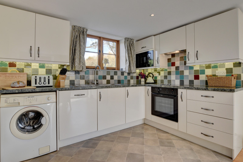 Kitchen/diner with electric hob and oven, microwave, fridge/freezer, washing machine and dishwasher