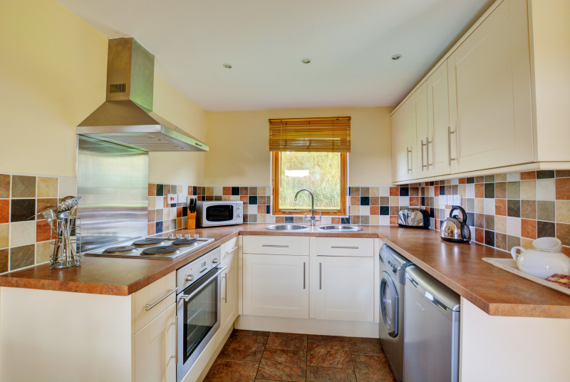 The well-fitted and equipped kitchen has lots of worktop space. 