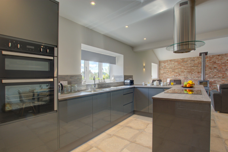 Open Plan Kitchen/Living Room with fitted units, built in oven, island with hob & extractor fan