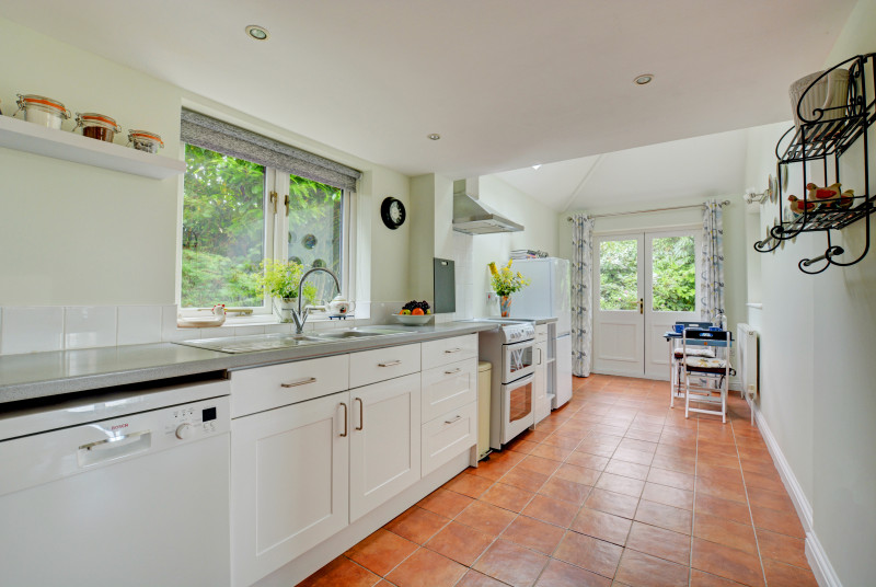 Light and airy kitchen with  built-in electric oven and hob, fridge/freezer, dishwasher, microwave and bistro table and chairs for two