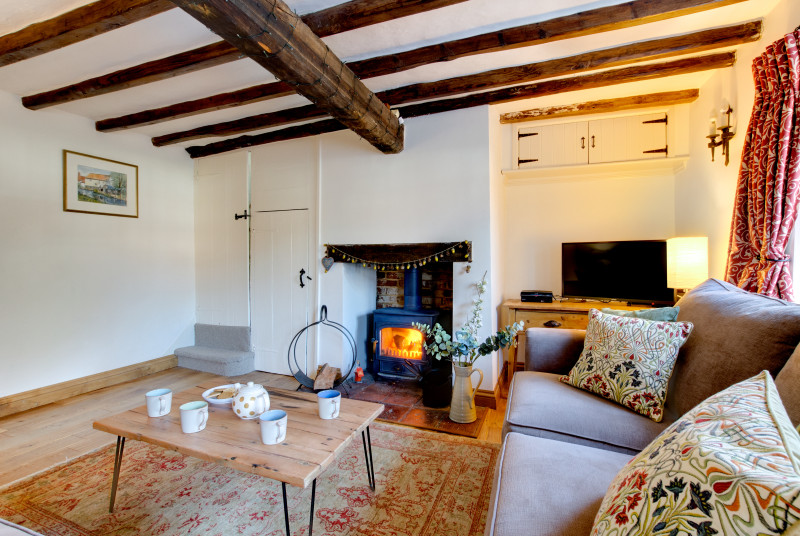 Cosy sitting room with TV and delightful wood burner