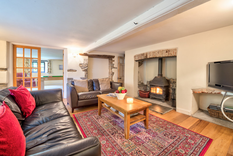 The sitting room has a cosy feel with the log burner lit