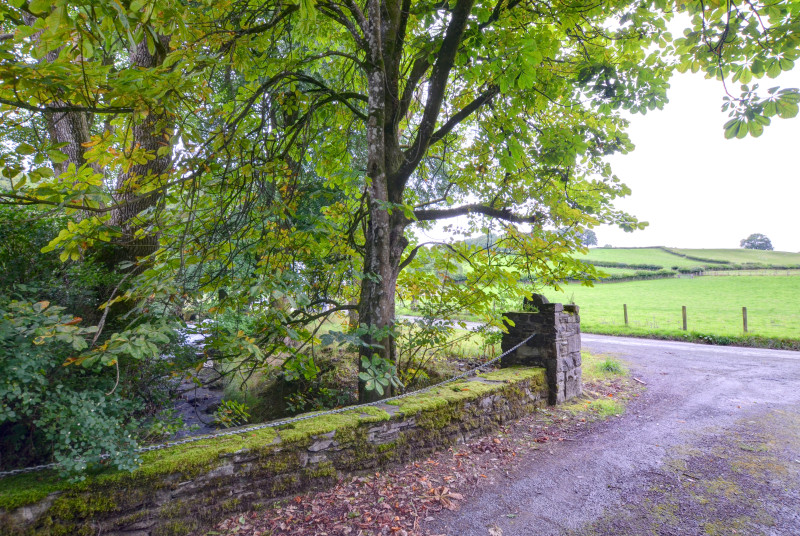 The property is surrounded by peaceful countryside with a stream
