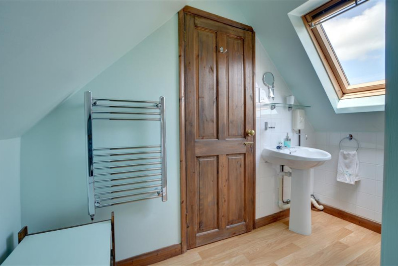 Shower room showing towel rail and hand basin