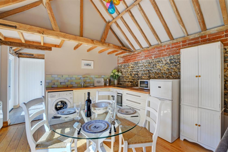 The kitchen is a lovely rustic room with electric oven and hob