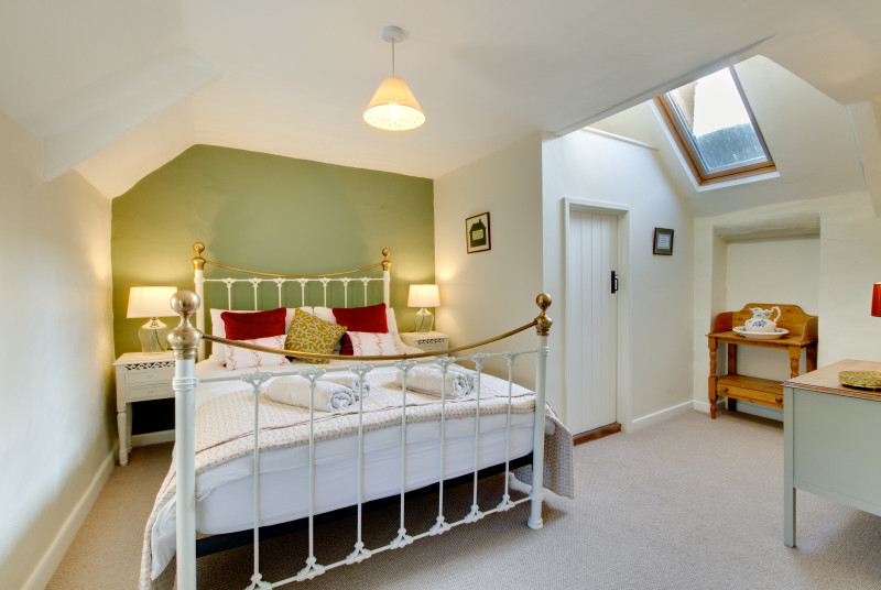 The king size bedroom has a lovely feature bedroom and ensuite