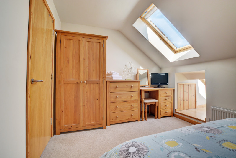 A wardrobe and dressing table provides ample storage in the bedroom 