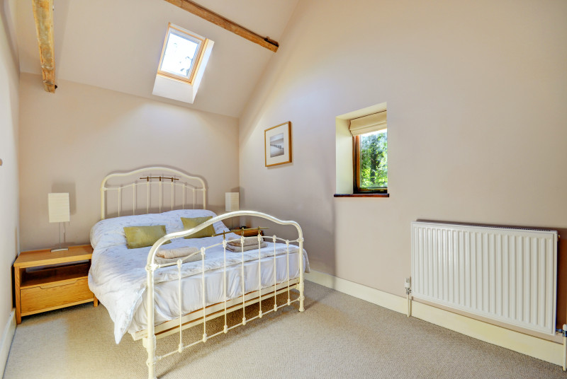 Bedroom three has a double bed with an attractive wrought iron bedstead