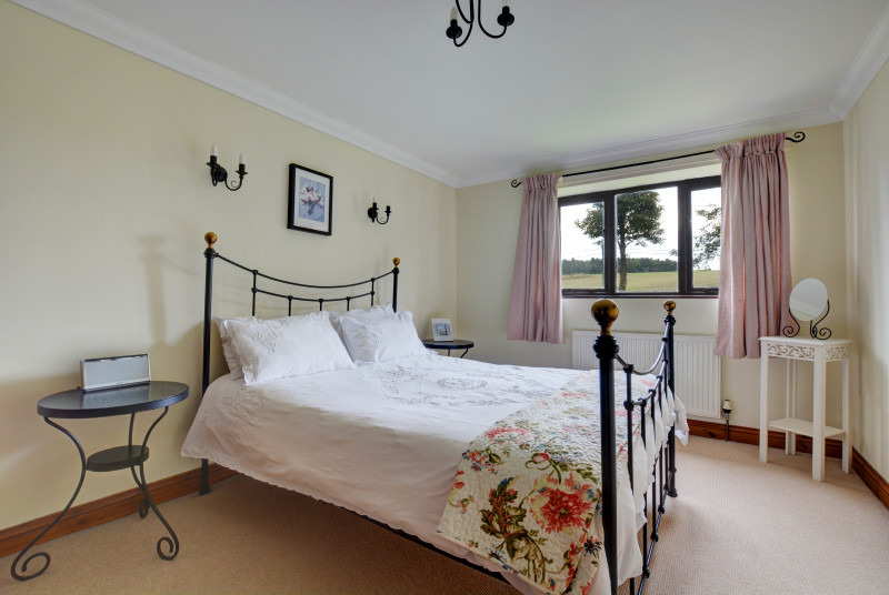 This comfortable king size bedroom which is a light and spacious room has the benefit of an ensuite bathroom