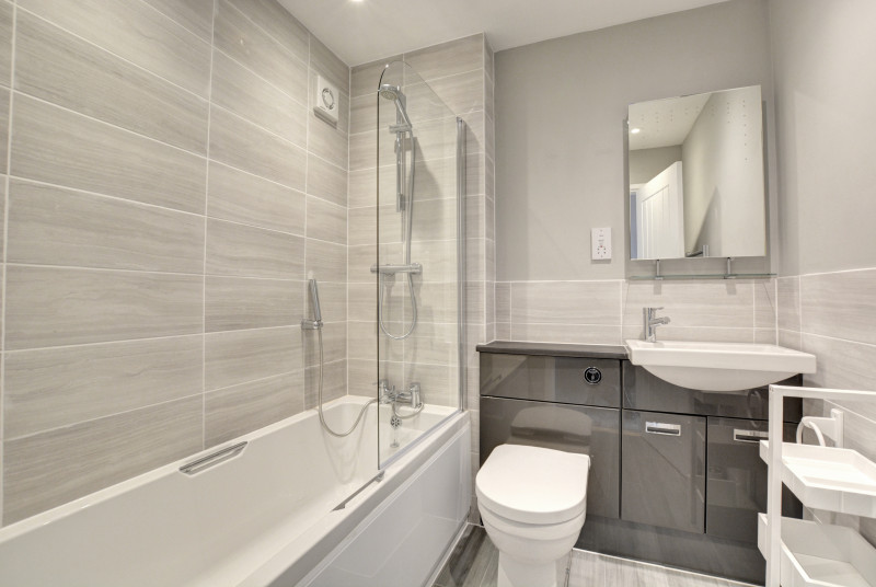 Bathroom with bath with shower over, washbasin and wc