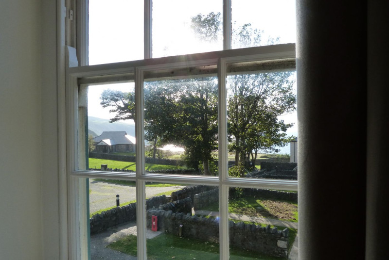 View from the bedroom over the lawn and out to sea