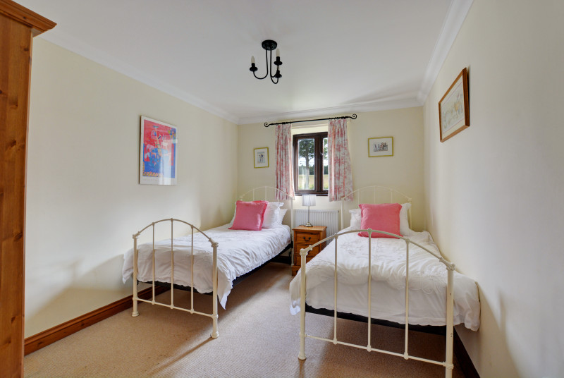 The pretty twin bedroom is light and airy