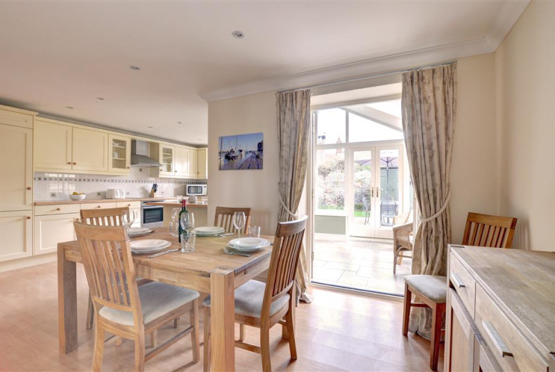 Dining area set for four looking into the conservatory