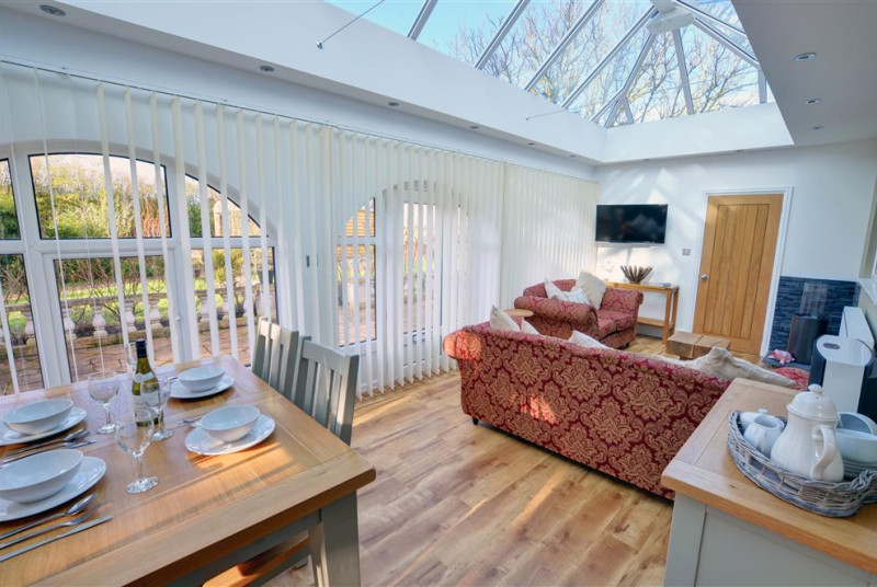 Beautiful conservatory with dining seating