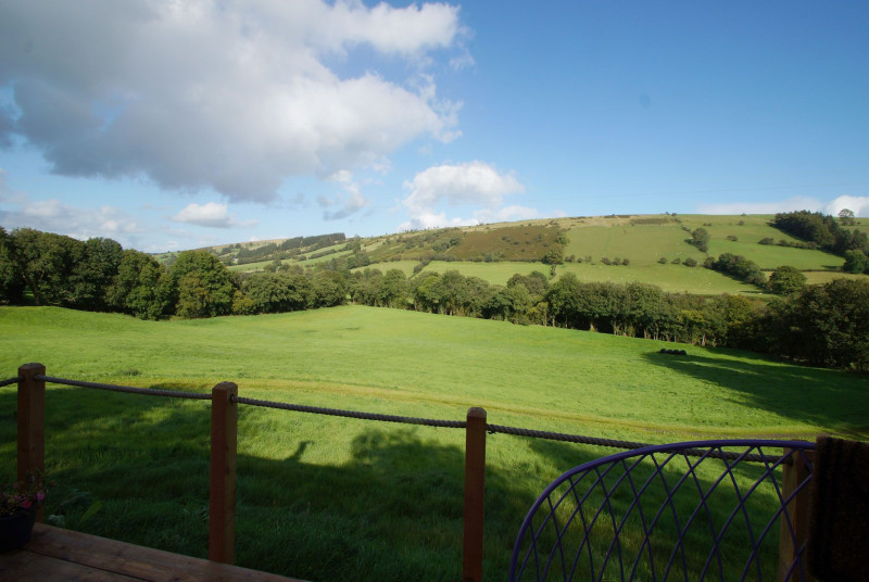 The fields and mountains in front of this glamping unit