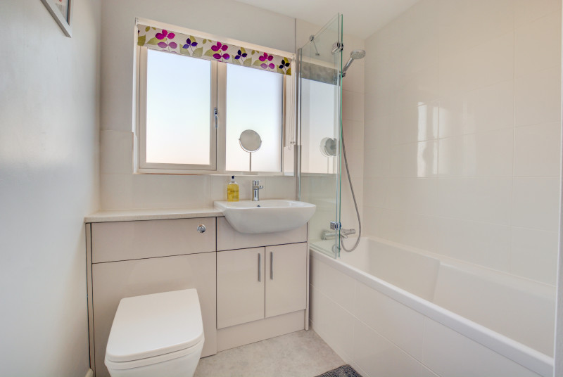 Bathroom with overhead shower on bath